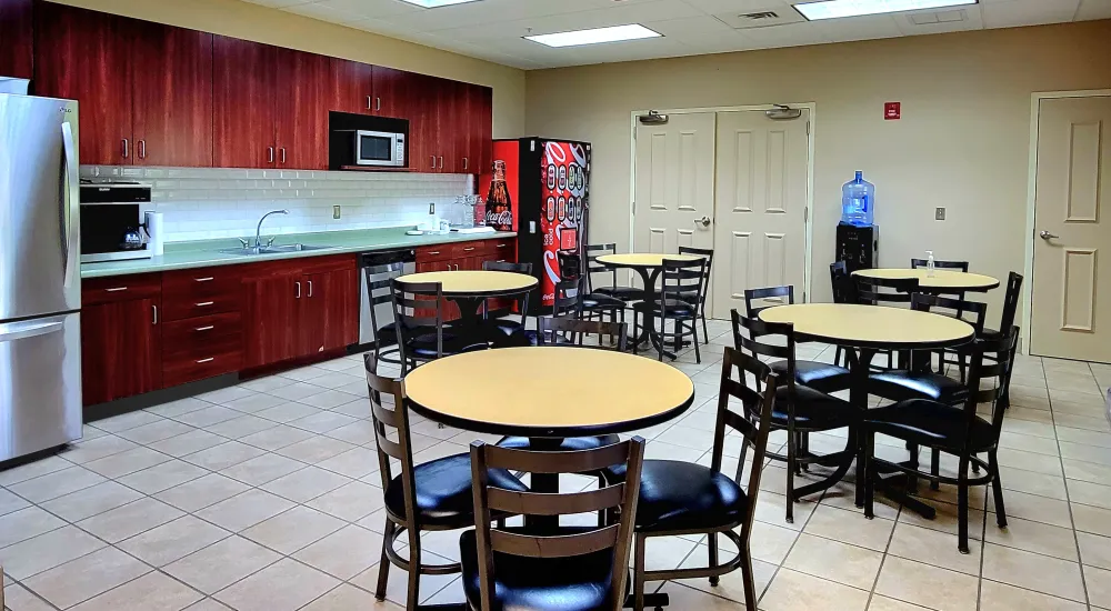 a kitchen with tables and chairs