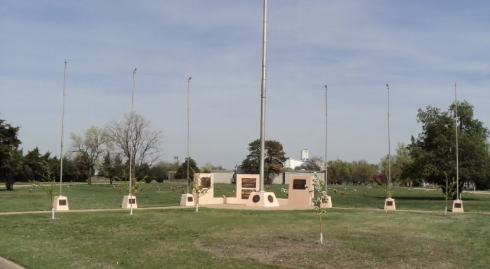 a field with a few white poles
