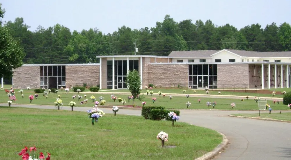 a building with a lawn and people in front of it