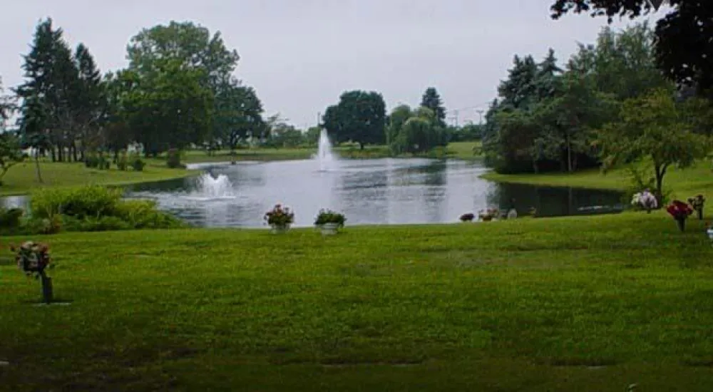 a pond with a fountain in it