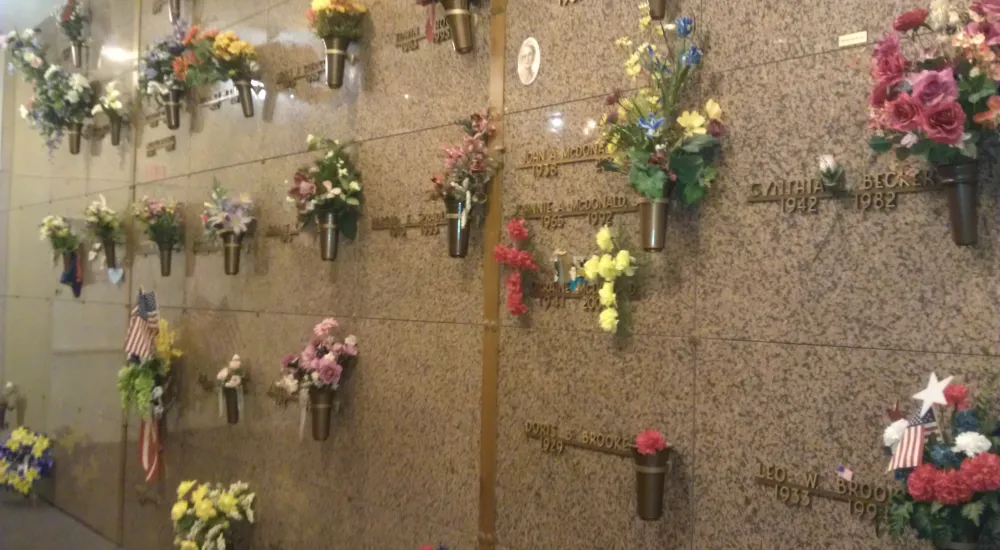 a wall with flowers and candles