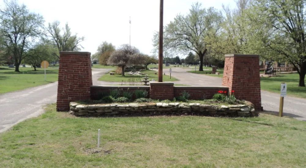 a brick structure in a grassy area