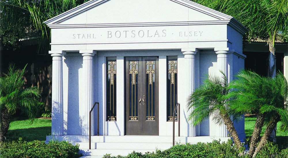 a white building with columns and a sign on it