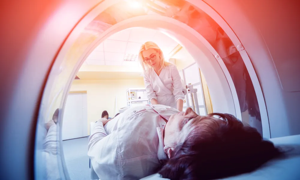 Doctor prepares a patient for MRI exam