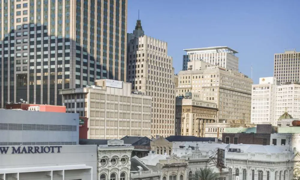Downtown cityscape featuring a mix of historic and modern buildings under clear blue sky.