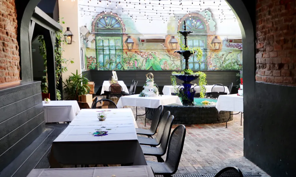 a courtyard with tables and chairs