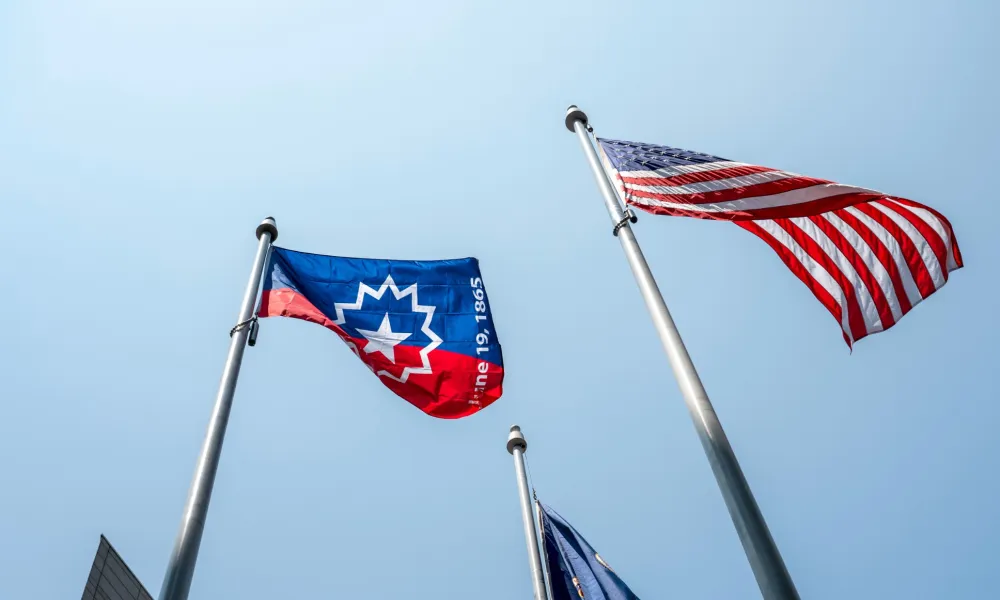 a group of flags on poles