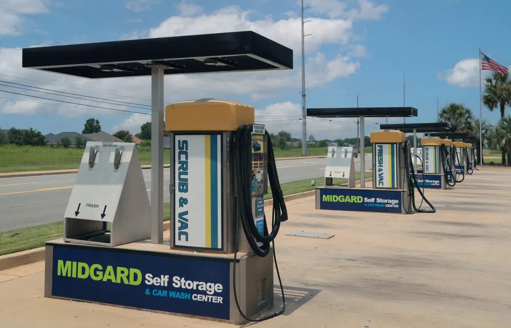 Car wash vacuum and scrub stations at Midgard Self Storage and Car Wash Center on a clear sunny day