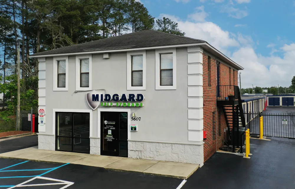 a white building with a black gate with 251 Menlove Avenue in the background