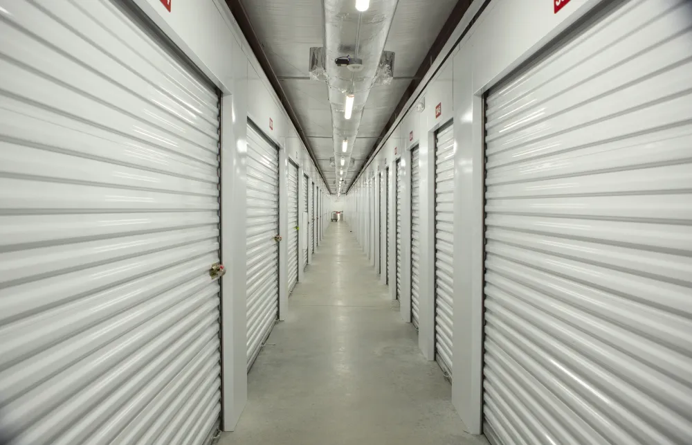 a long hallway with white lockers