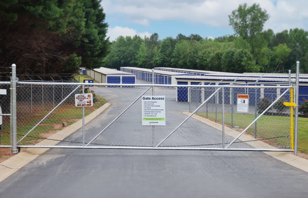 a road with a fence and a building in the background