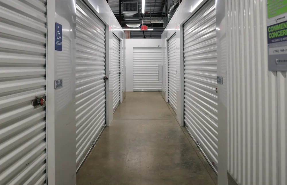 a long hallway with white lockers