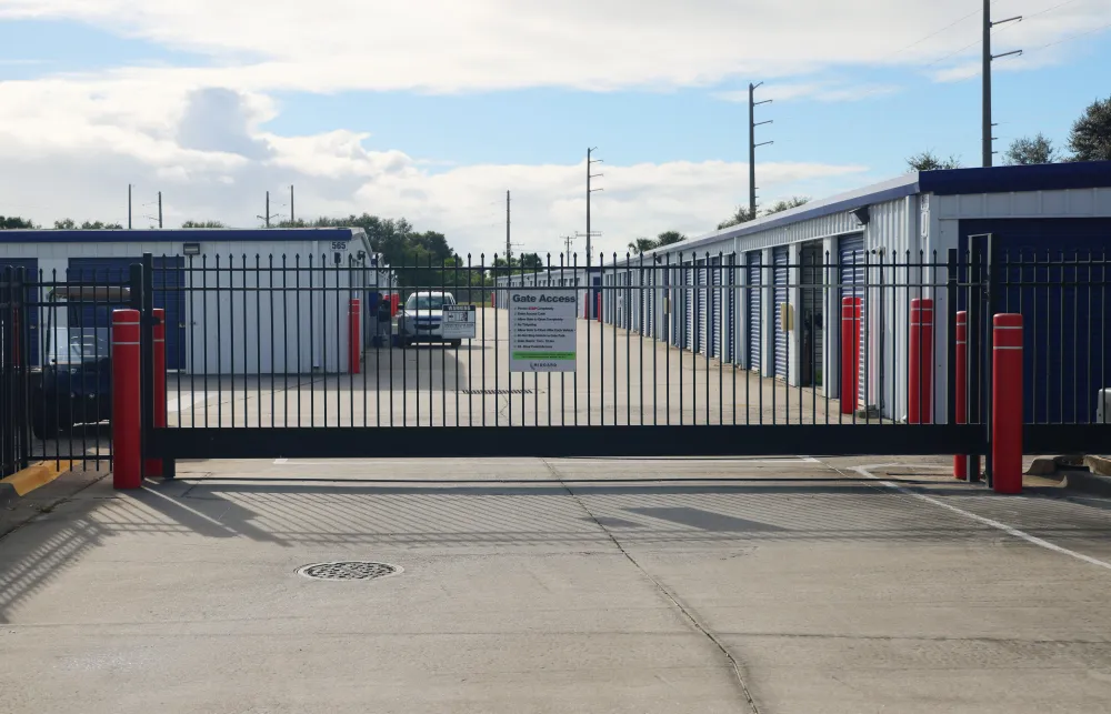 a road with a fence and cars on it