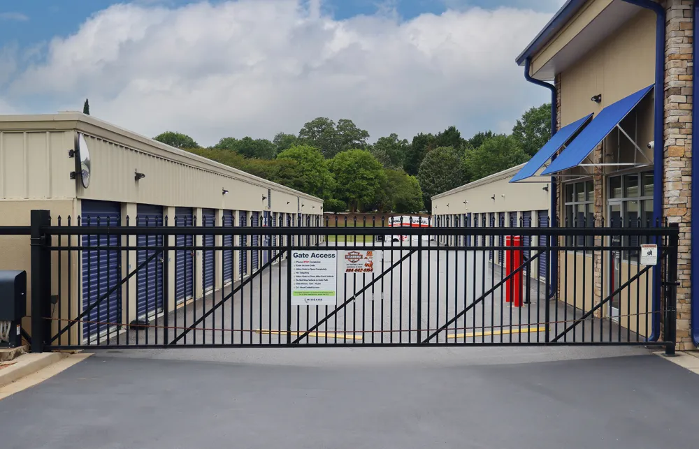 a black gate with a sign on it