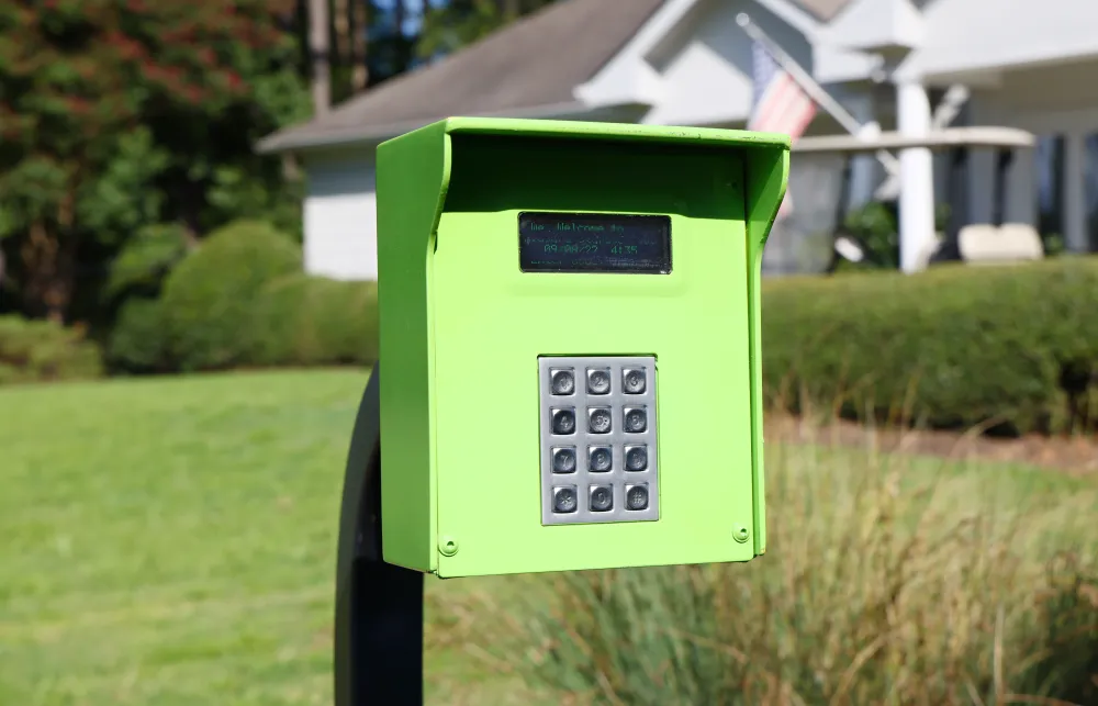 a green mailbox in a yard