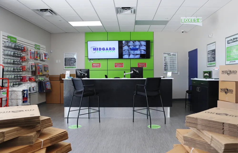 a room with a table chairs and shelves with signs on the wall