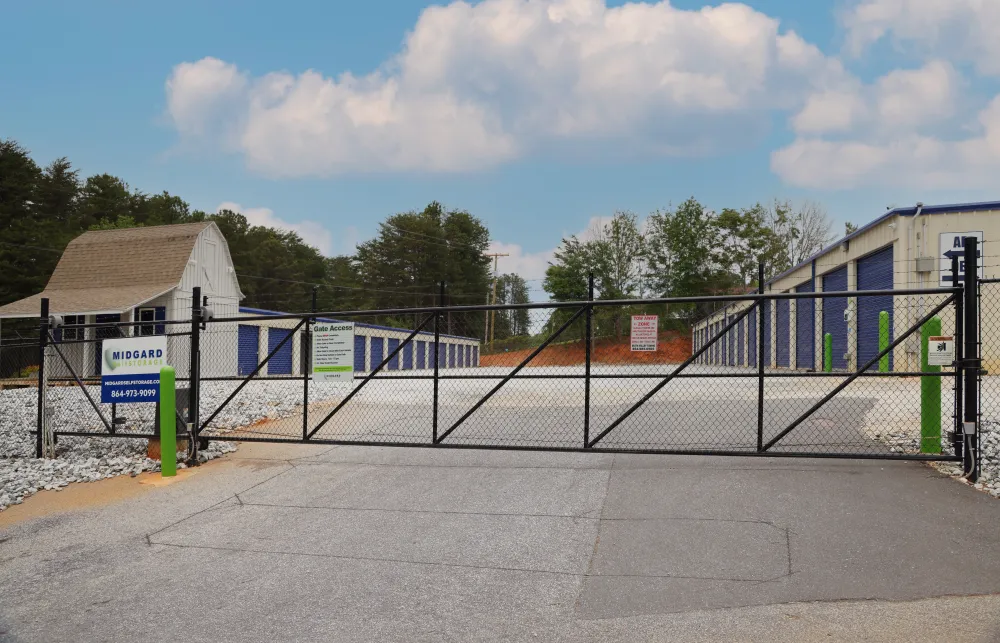 a fenced off area with a building in the background