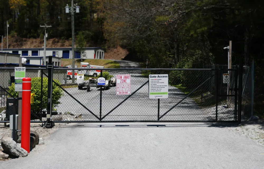 a road with a fence and signs