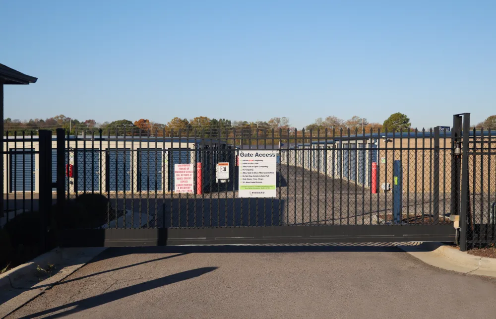 a black fence with a sign on it