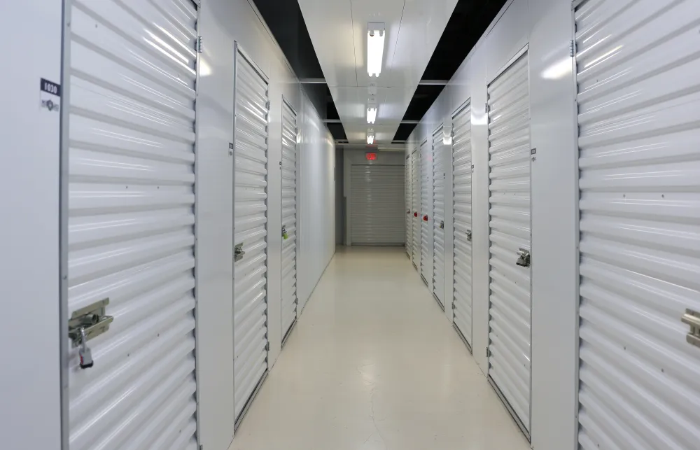 a long hallway with white lockers