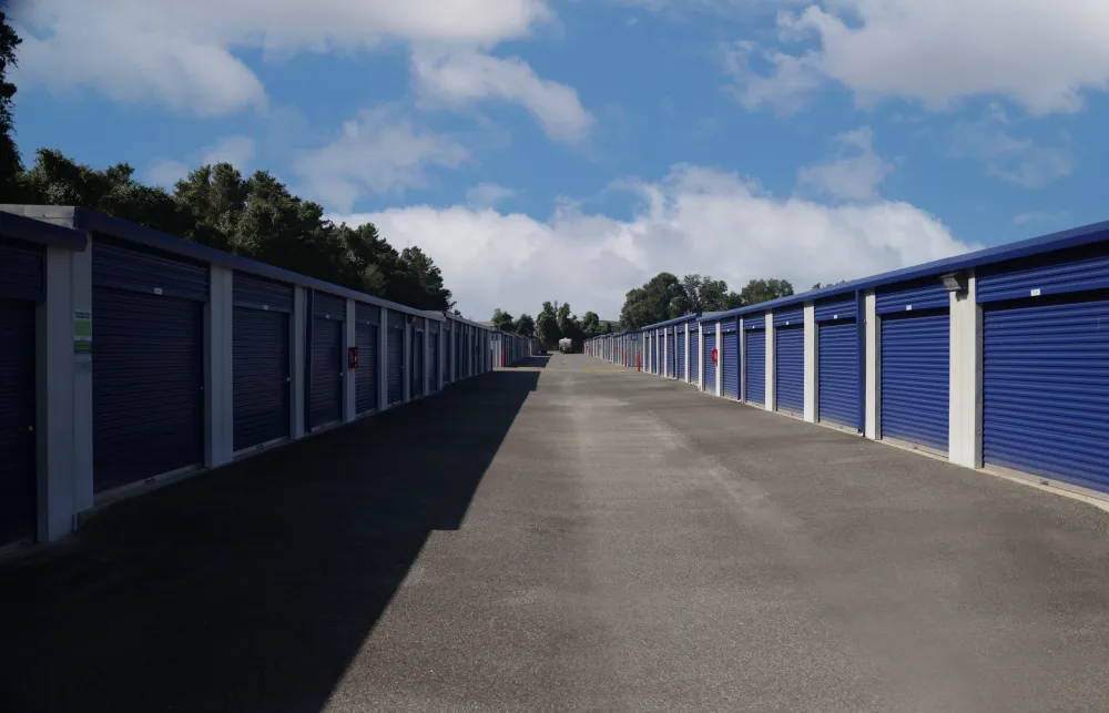 a row of metal fenced in metal containers