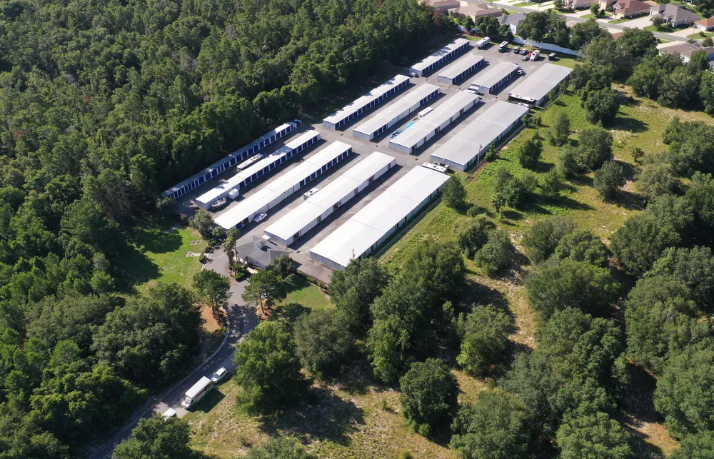 a large building with many windows surrounded by trees