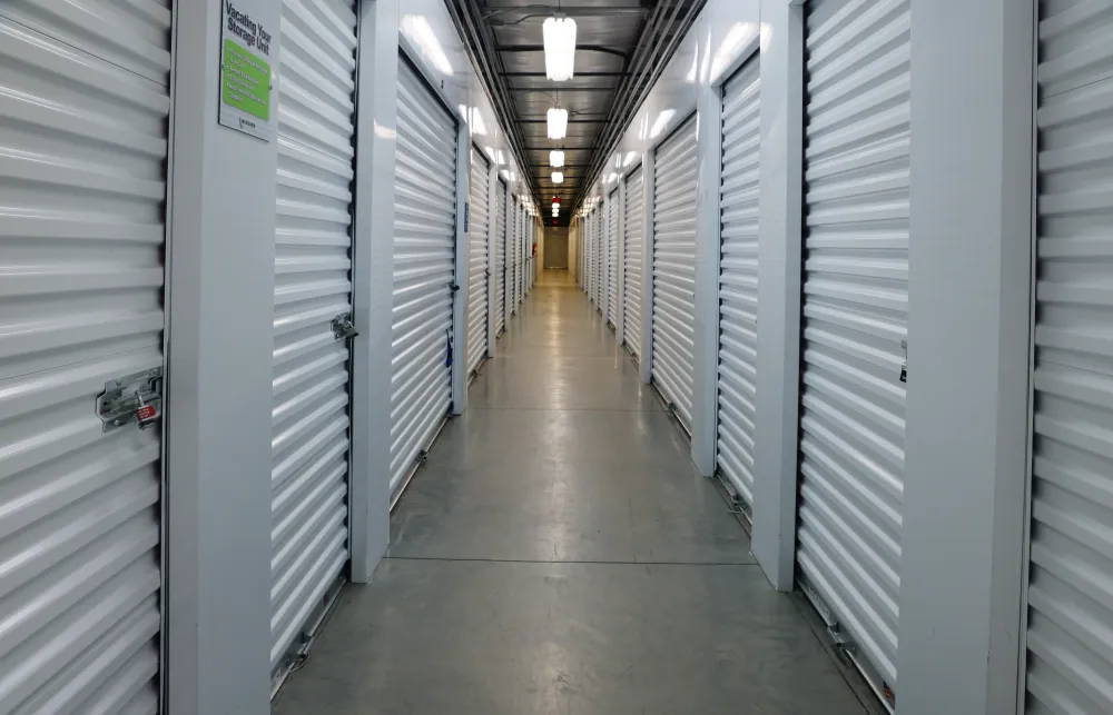 a long hallway with white lockers