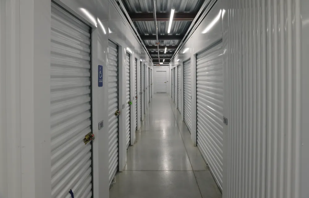 a long hallway with white lockers