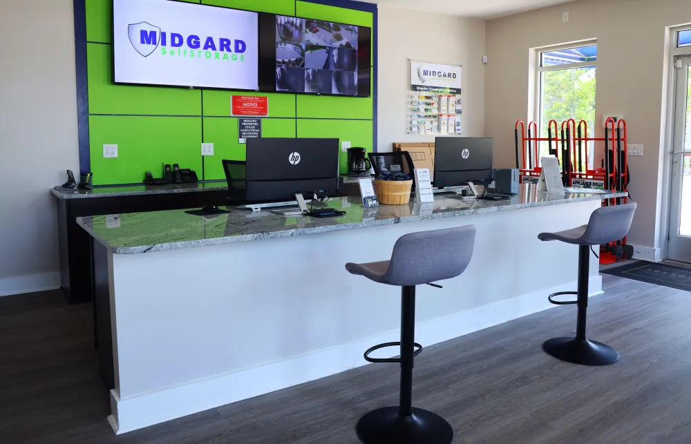 a desk with chairs and computers