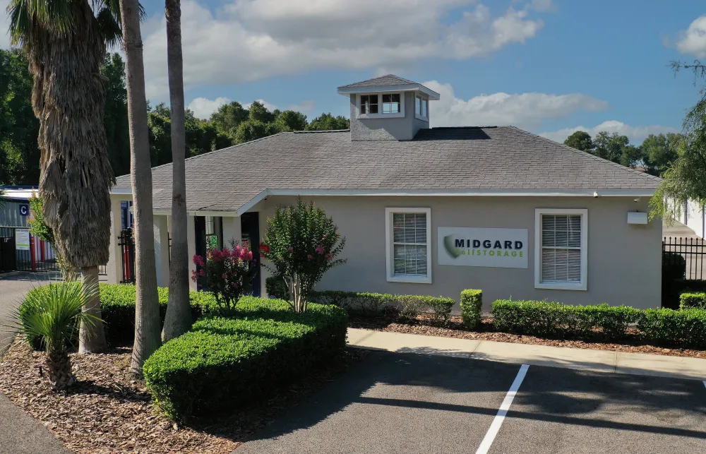 a building with palm trees and bushes