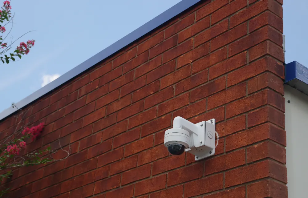 a camera on a brick wall