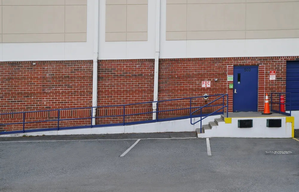 a brick wall with a blue railing