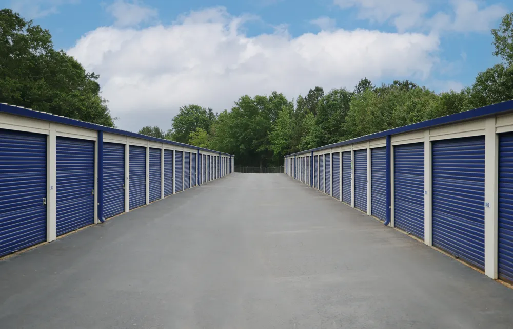 a row of blue and white metal fenced in doors