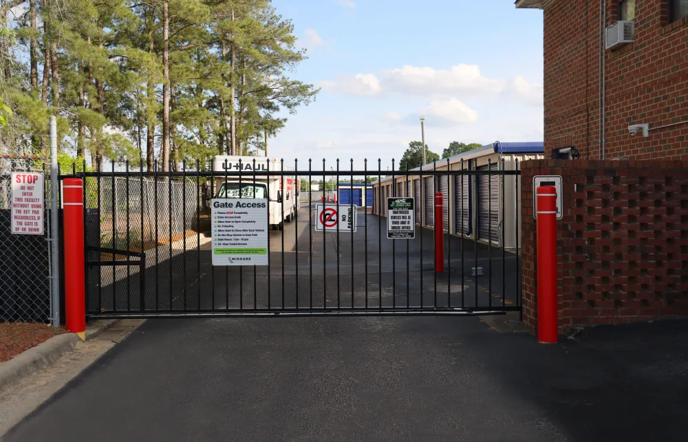 a black gate with red and white signs on it