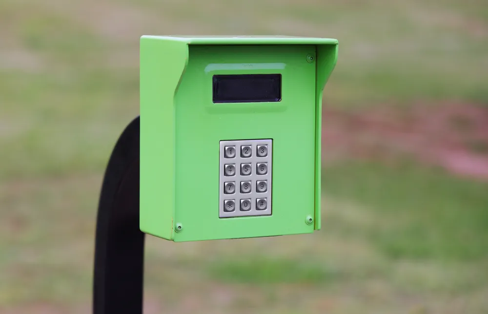 a green phone on a black stand