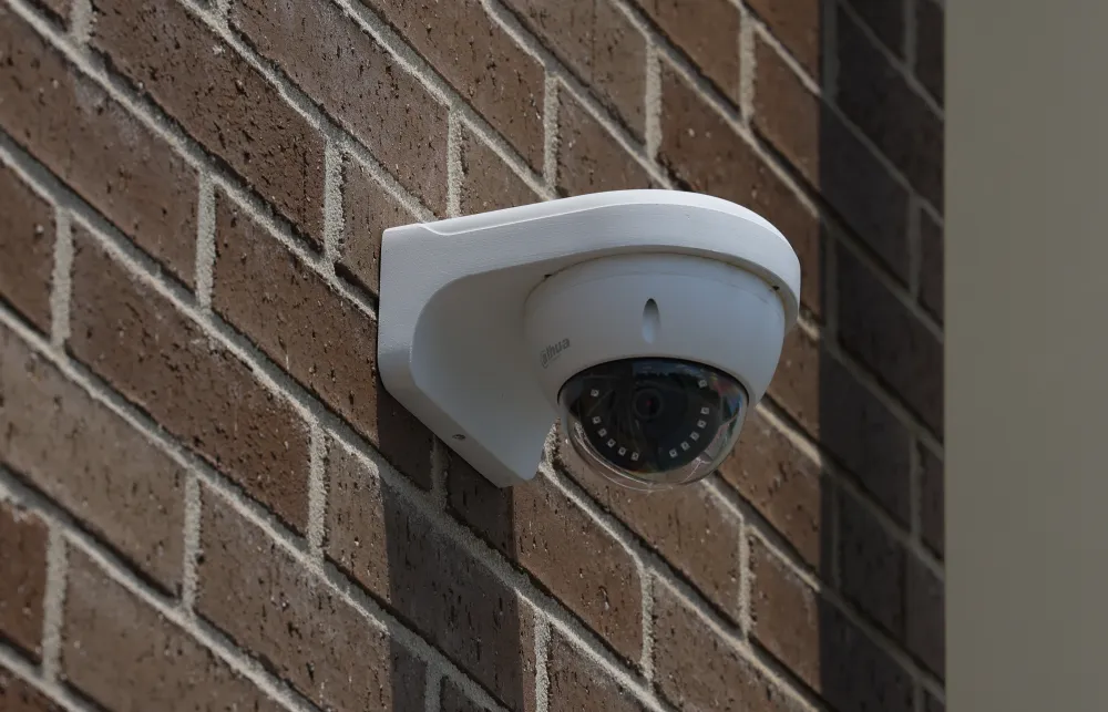 a white light bulb on a brick wall