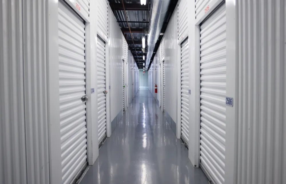 a long hallway with white lockers