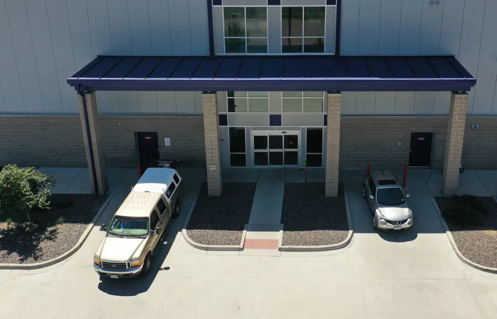 a bus and a car parked outside a building