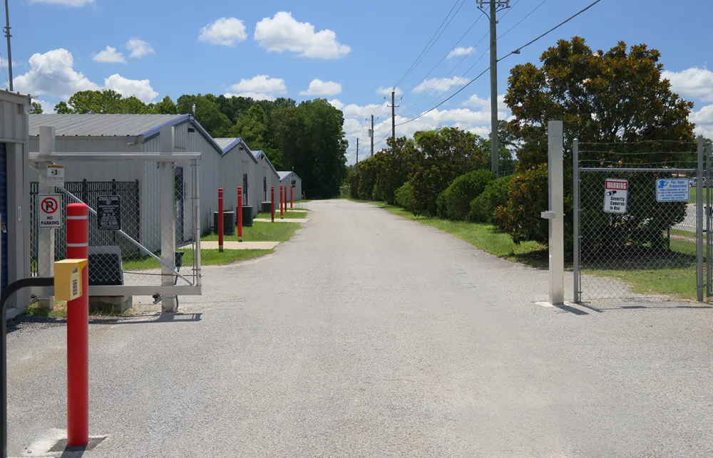 a road with a fence and a gate on the side