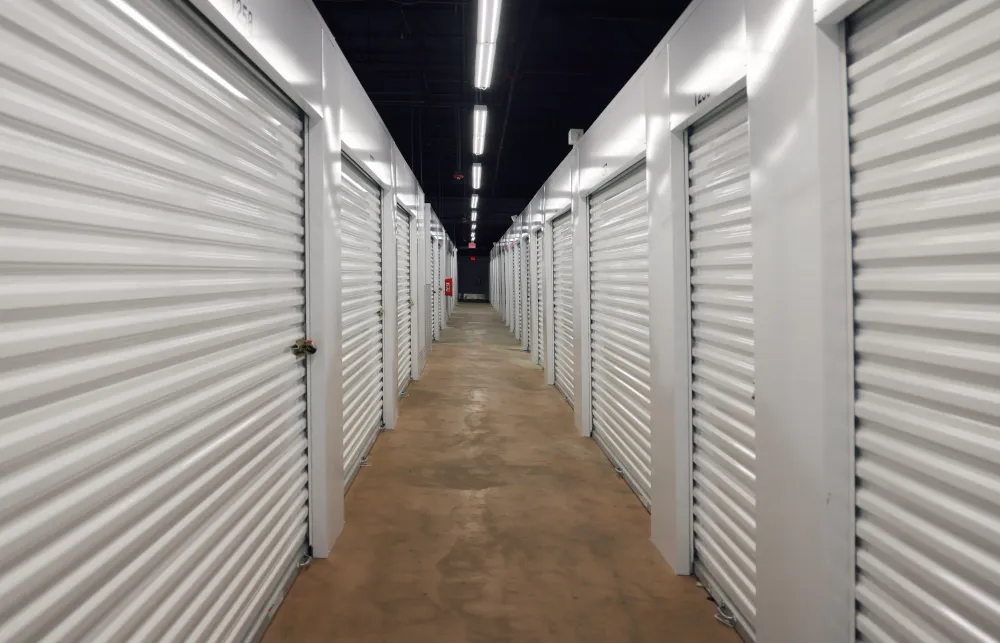 a long hallway with rows of white lockers