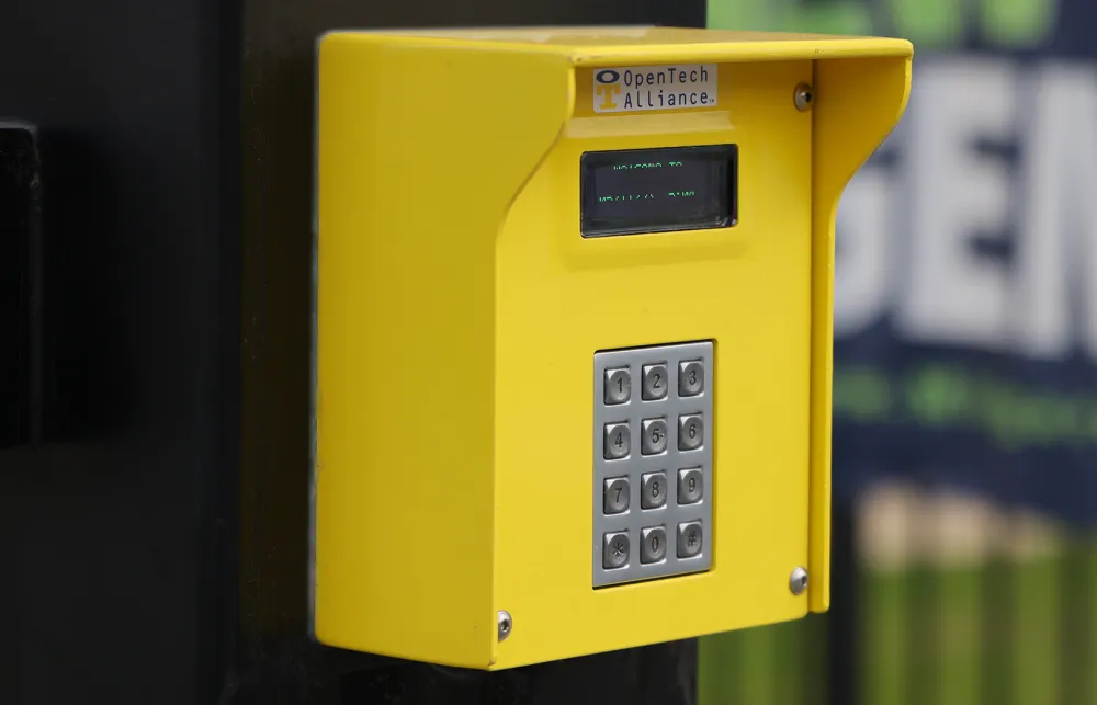 a yellow telephone on a pole