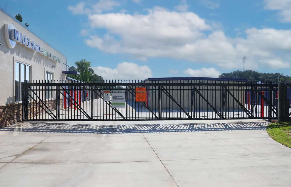 a black gate with a building in the background