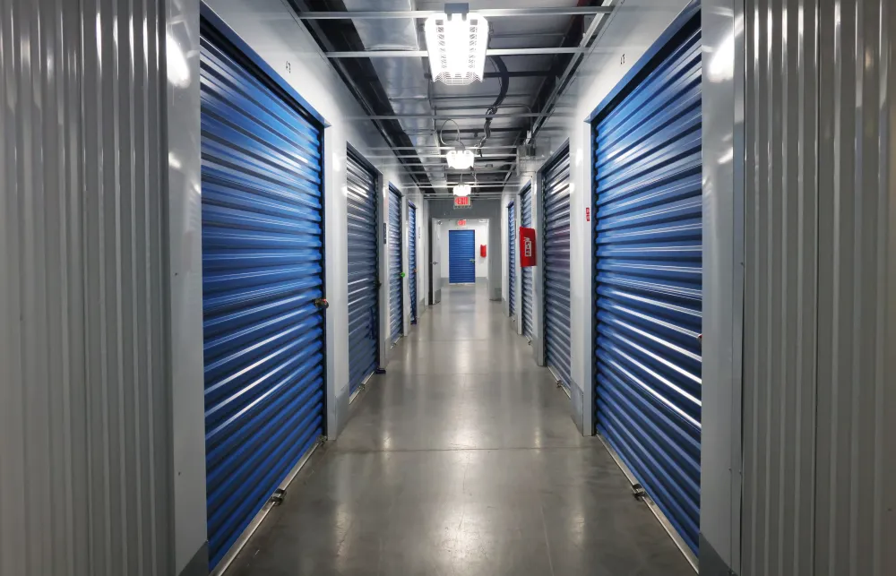 a long hallway with blue lockers