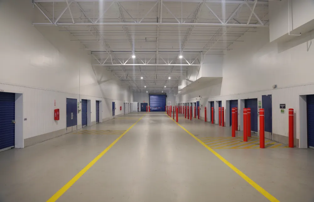 a long hallway with red and blue doors