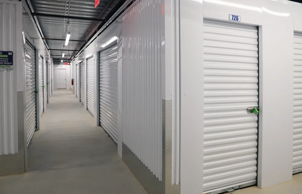 a long hallway with white lockers