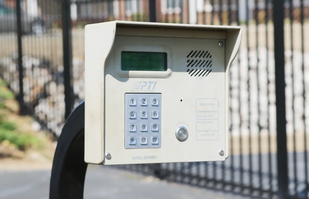 a white rectangular object with buttons and a screen on a metal surface