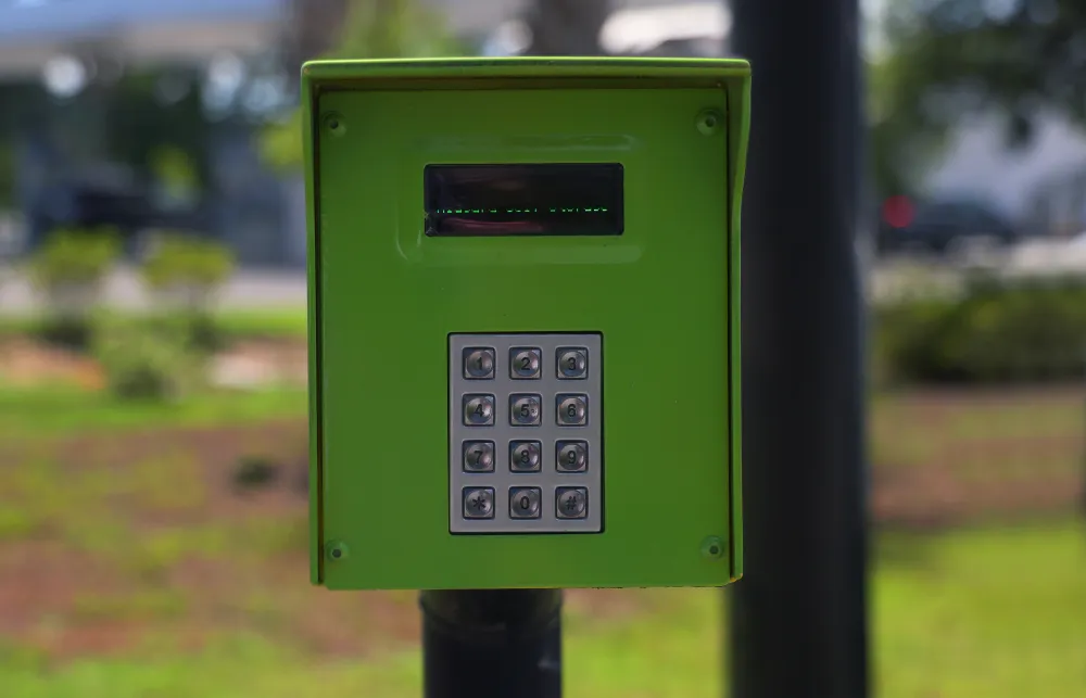 a green and black parking meter