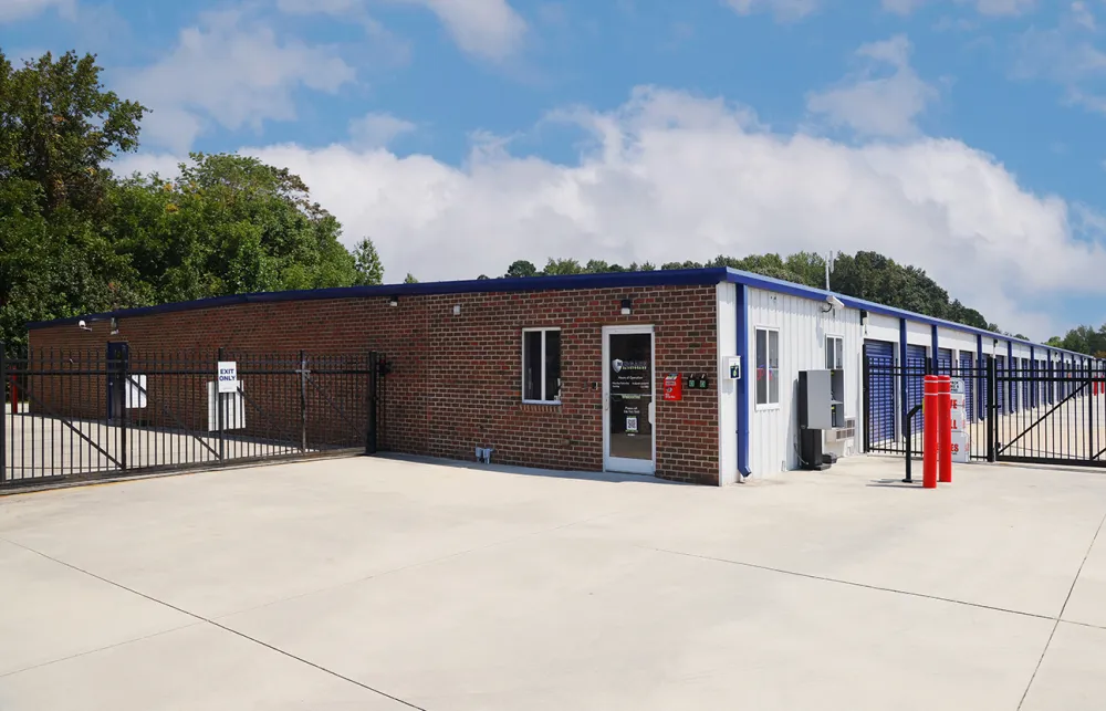 a brick building with a fence around it