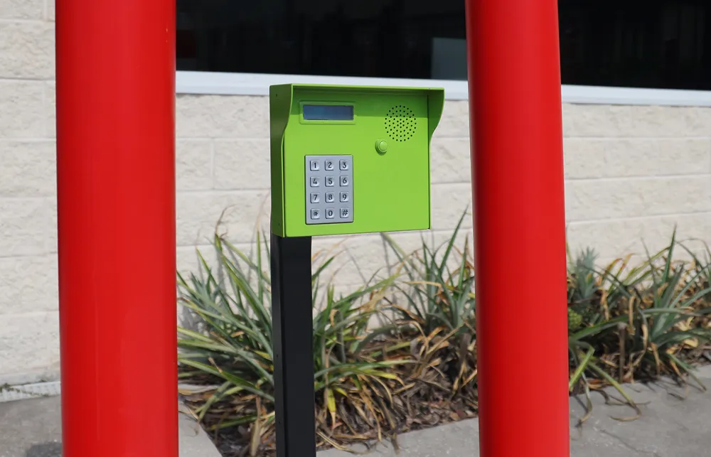 a green and white box on a red pole