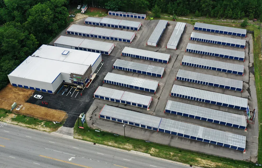 Aerial view of a large self-storage facility with multiple rows of storage units and an office building.